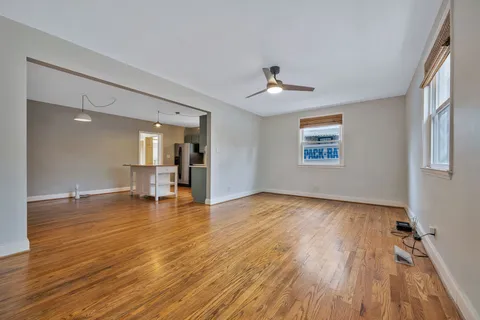 a view of empty room with wooden floor and fireplace