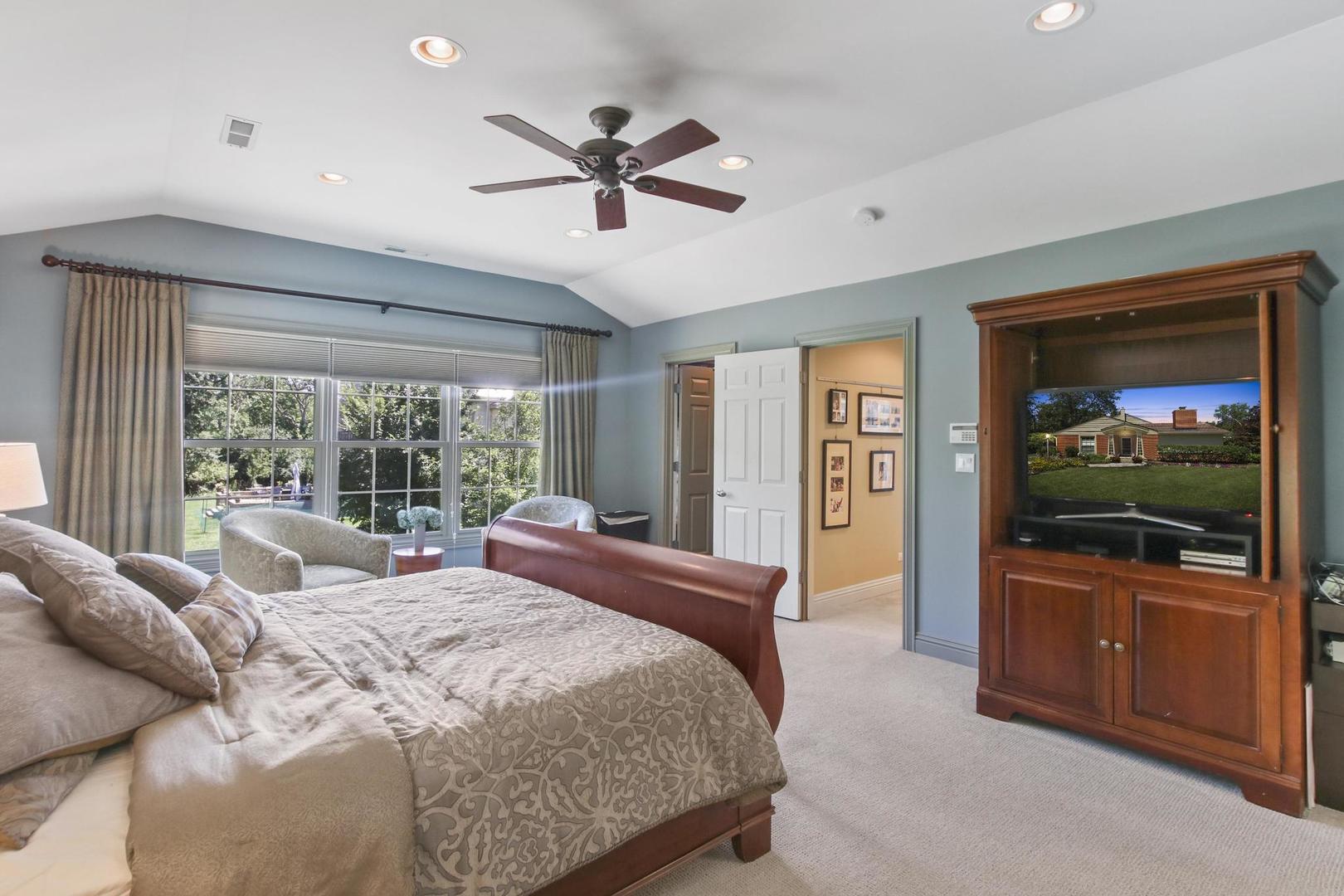 720 Becker Road Glenview, IL 60025 - Photo 20 of 44 a bedroom with a large bed and a flat tv screen