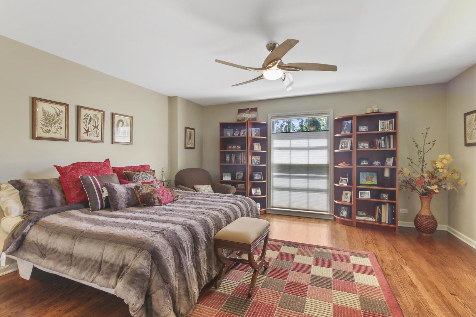 720 Becker Road Glenview, IL 60025 - Photo 31 of 44 a bedroom with a large bed and a book shelf