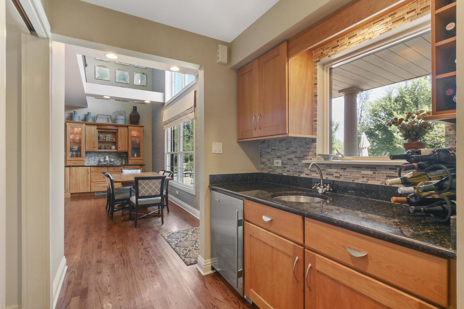 720 Becker Road Glenview, IL 60025 - Photo 8 of 44 a kitchen with granite countertop a sink and a window