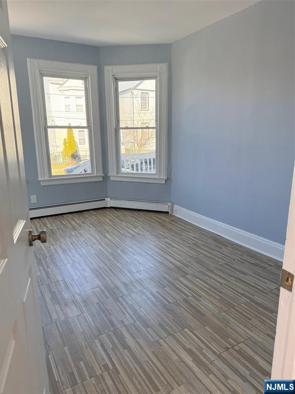 2 North 4th Street, Unit 3 Paterson, NJ 07522 - Photo 1 of 2 an empty room with wooden floor and windows