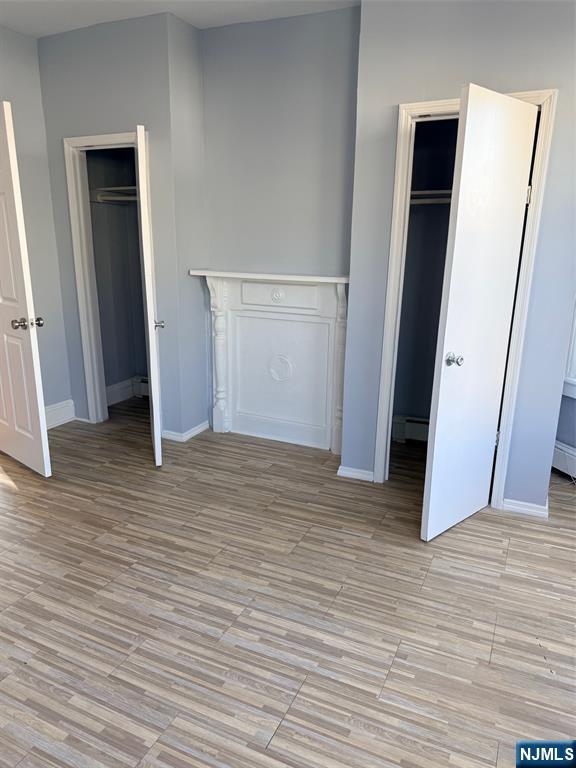 2 North 4th Street, Unit 3 Paterson, NJ 07522 - Photo 2 of 2 an empty room with wooden floor and closet