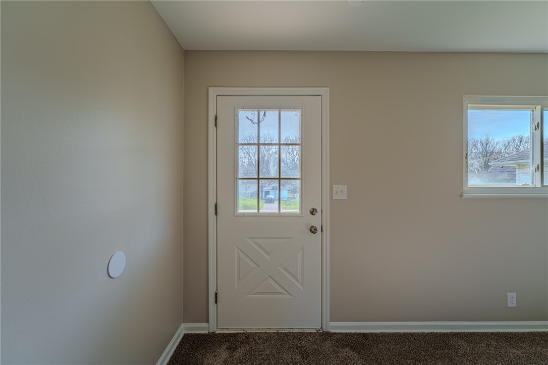 1005 Burt Street Springfield, OH 45505 - Photo 5 of 33 This bright space features a glass-paneled entry door and natural light from the window.