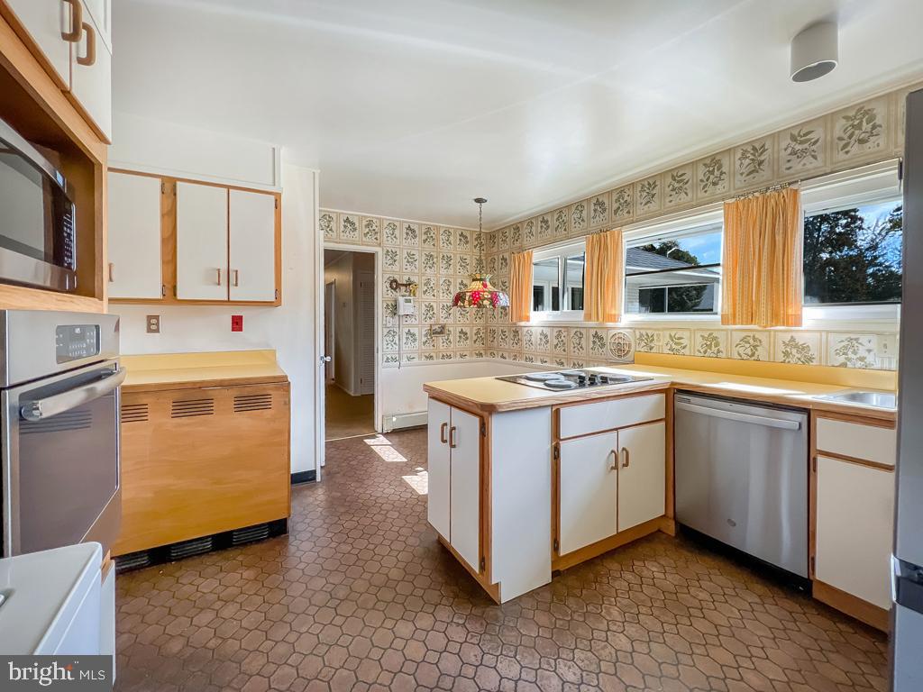 37 Full Turn Road Levittown, PA 19056 - Photo 9 of 38 a kitchen with stainless steel appliances granite countertop a sink stove and refrigerator