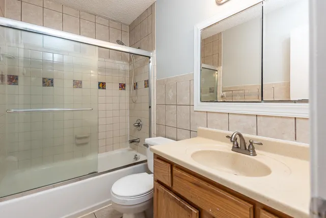 an empty room with a window and a ceiling fan