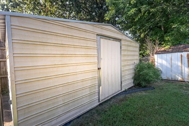 a view of a backyard with wooden fence