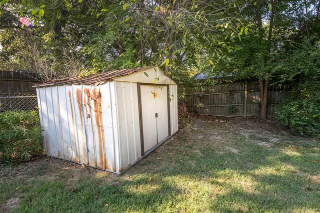a side view of a house with a yard