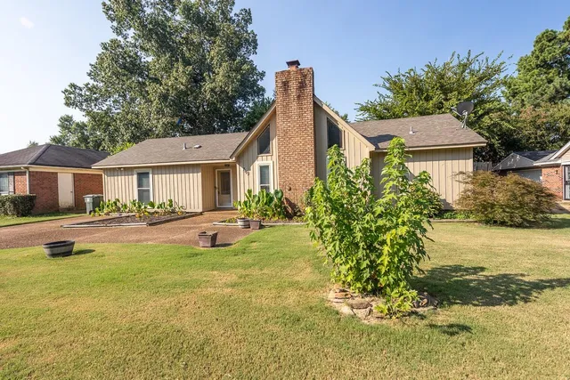 a view of a house with swimming pool and a yard