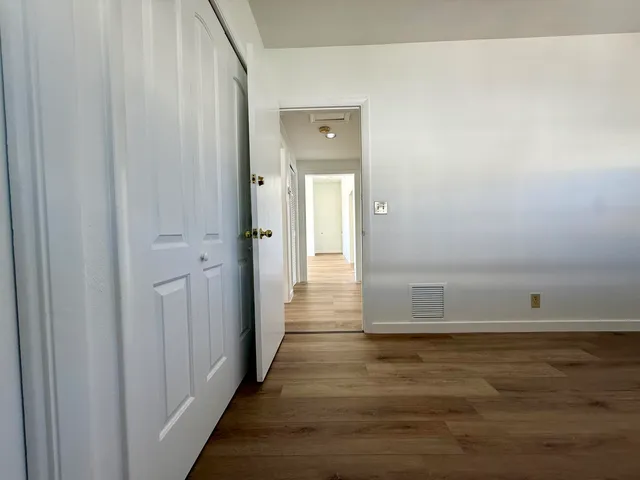 a view of a hallway with wooden floor