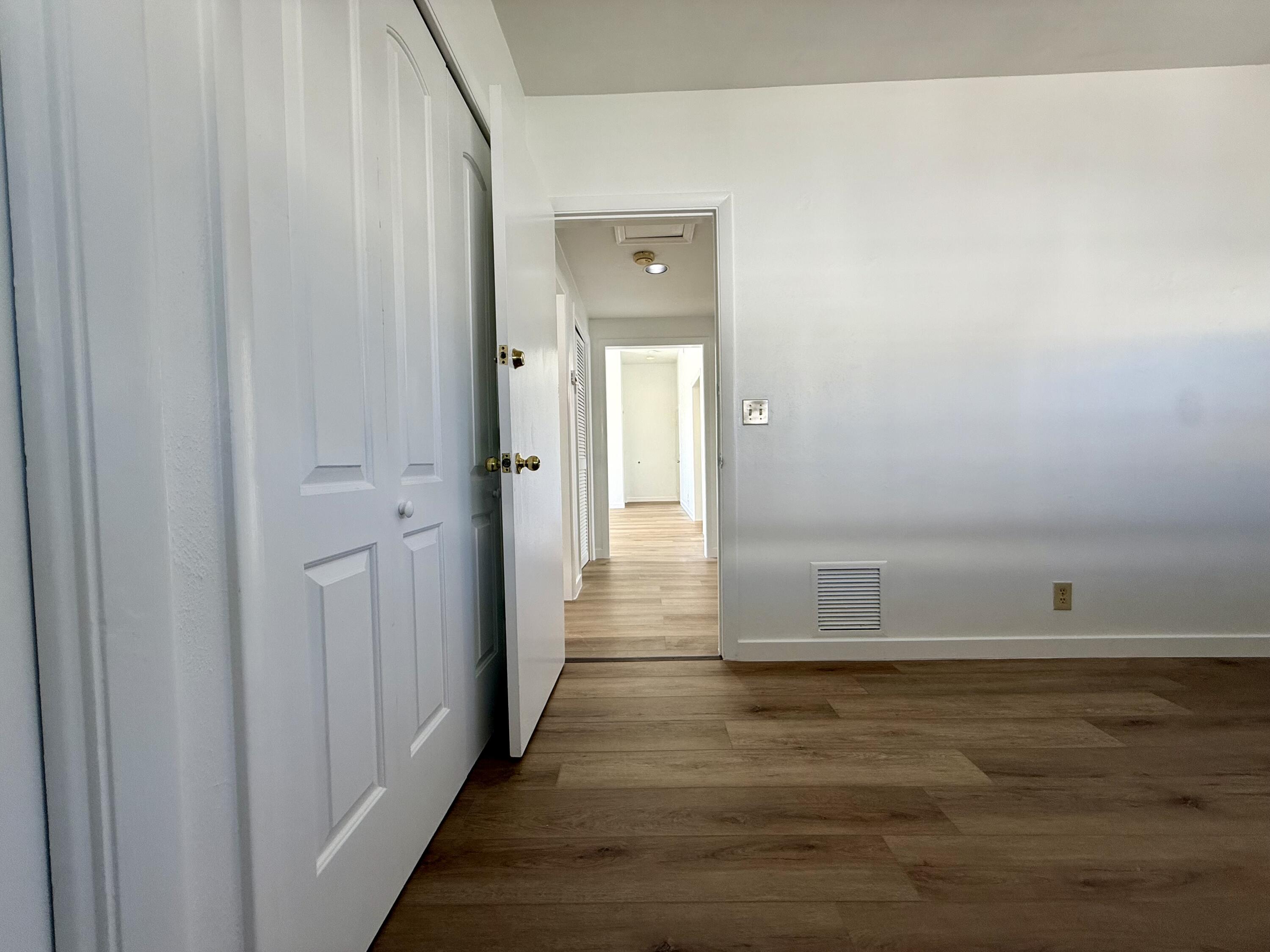 1165 East Atlantic Avenue, Unit A Delray Beach, FL 33483 - Photo 16 of 30 a view of a hallway with wooden floor