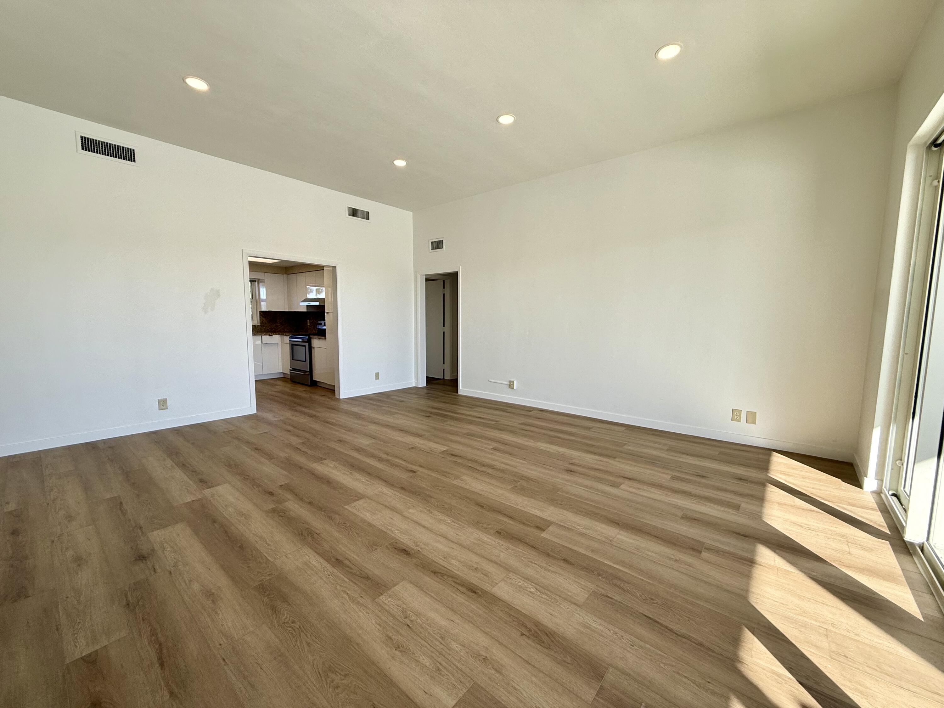 1165 East Atlantic Avenue, Unit A Delray Beach, FL 33483 - Photo 2 of 30 a view of empty room with wooden floor