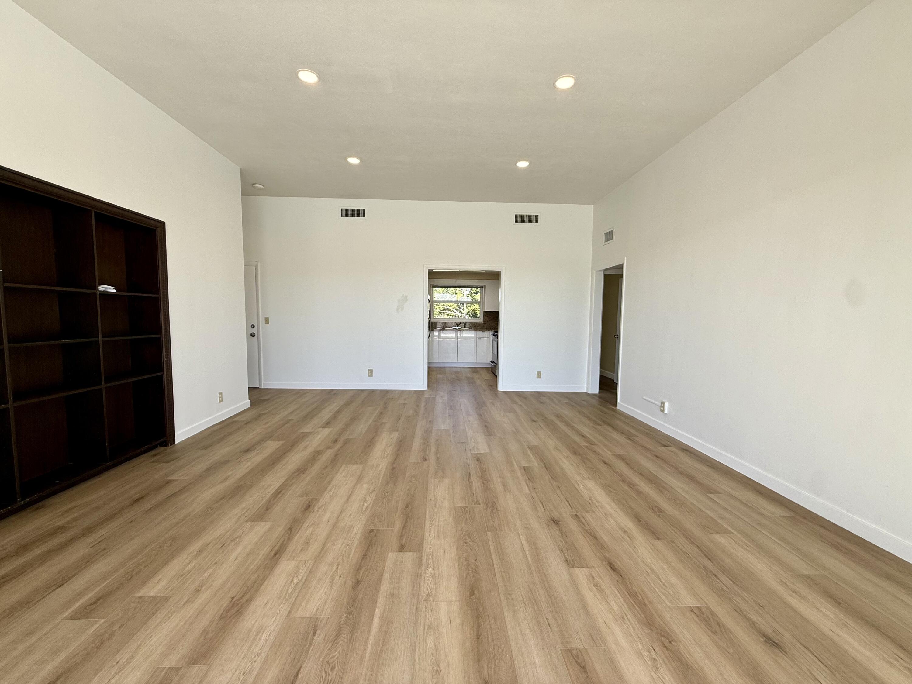 1165 East Atlantic Avenue, Unit A Delray Beach, FL 33483 - Photo 22 of 30 a view of empty room with closet and wooden floor