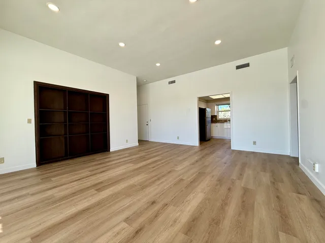 a room with wooden floor and couch