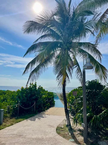 a view of multiple houses with a yard and car parked