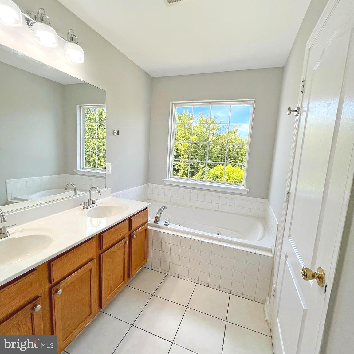 2718 Zeek Lane Lanham, MD 20706 - Photo 16 of 32 a bathroom with a tub sink and mirror