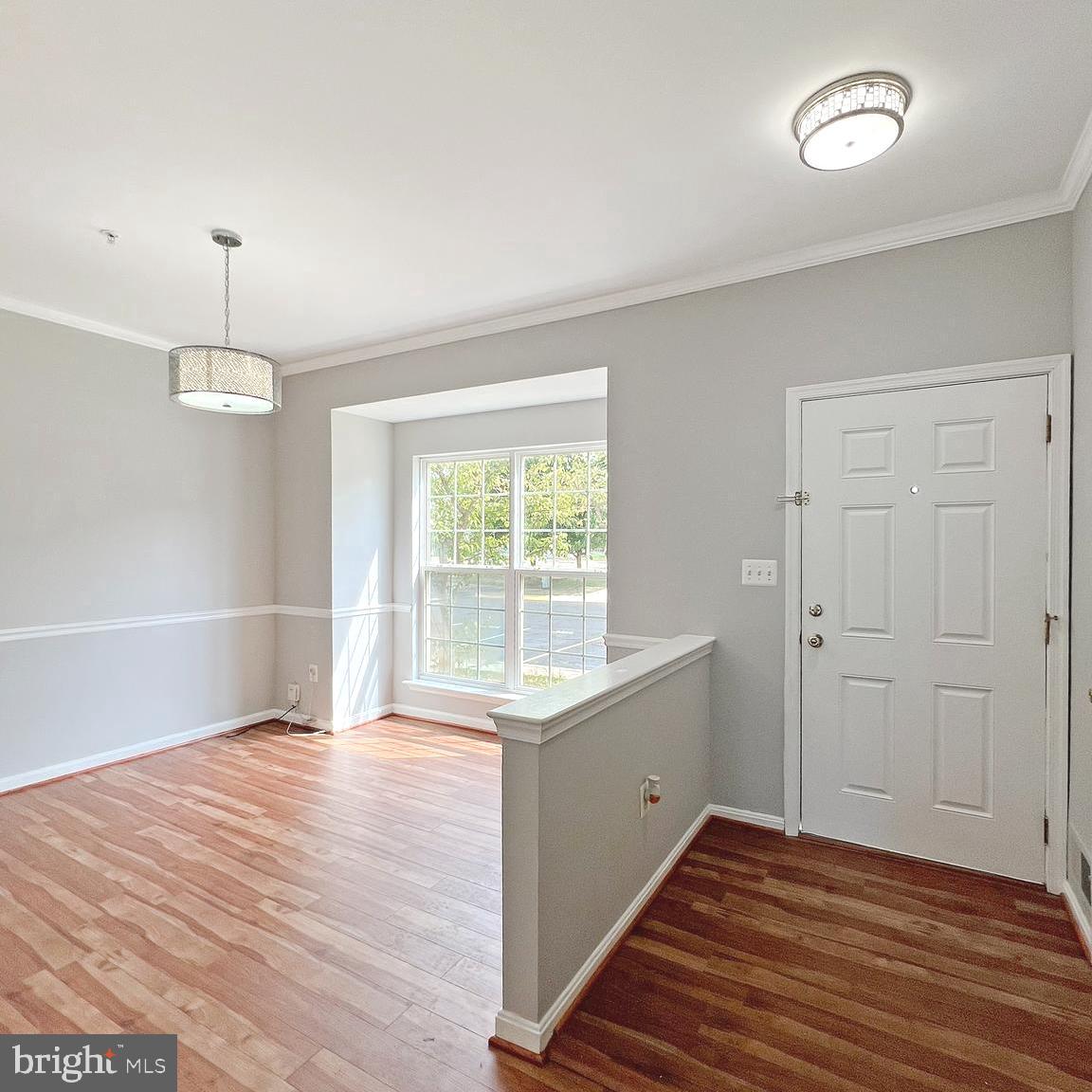 2718 Zeek Lane Lanham, MD 20706 - Photo 2 of 32 a view of an empty room with wooden floor and a window
