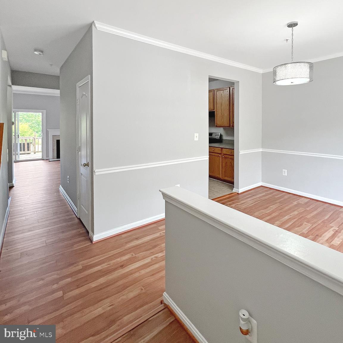 2718 Zeek Lane Lanham, MD 20706 - Photo 3 of 32 a hallway with wooden floor windows and chandelier