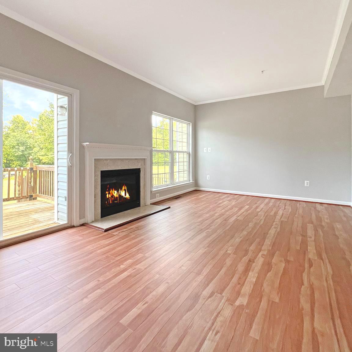 2718 Zeek Lane Lanham, MD 20706 - Photo 8 of 32 a view of an empty room with wooden floor fireplace and a window
