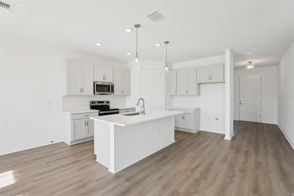 a kitchen with white cabinets and white appliances