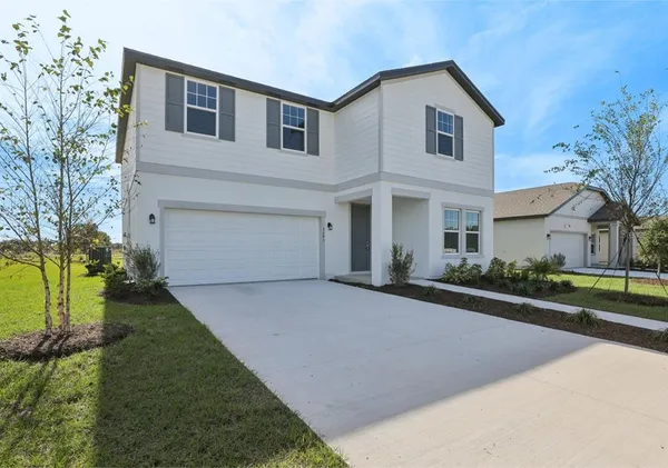 a front view of a house with a yard and garage