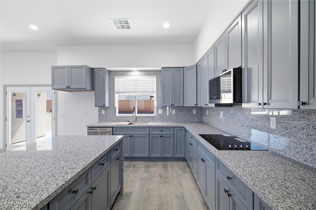 1061 Factory Road Pahrump, NV 89048 - Photo 15 of 41 Modern kitchen with granite countertops and sleek cabinetry.