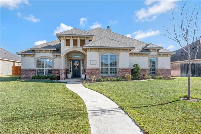 a front view of a house with a garden
