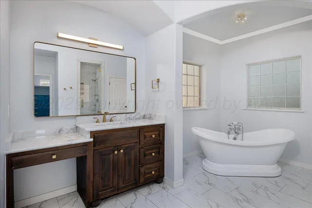 a spacious bathroom with a shower sink and mirror