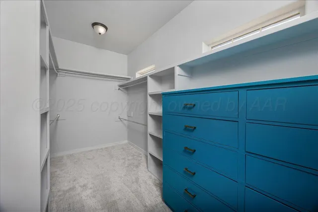 an empty room with closet and fan