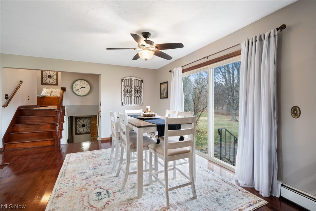 8221 Stone Road Medina, OH 44256 - Photo 6 of 35 Dining room with ceiling fan, baseboard heating, and hardwood flooring