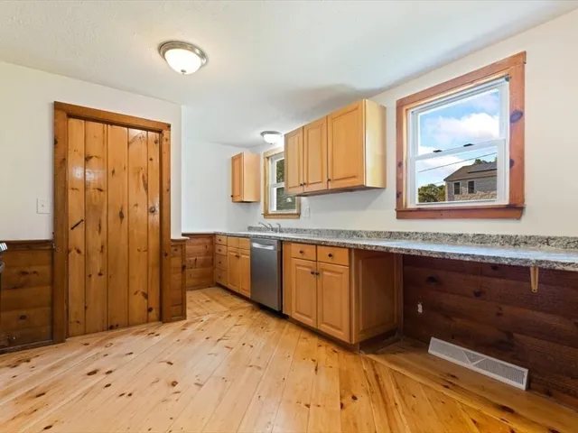 a kitchen with stainless steel appliances granite countertop a sink and cabinets