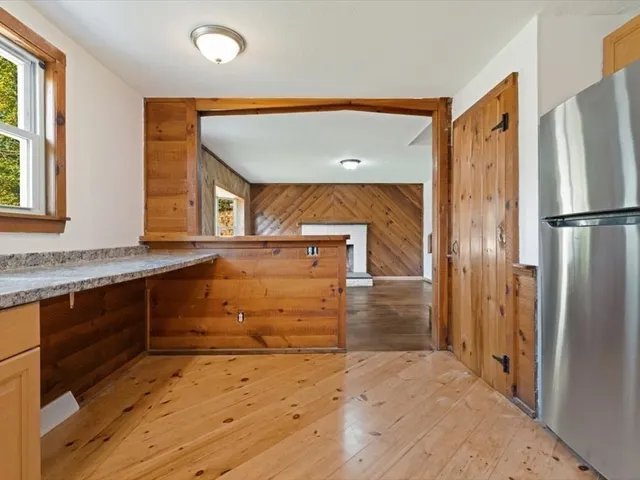 a view of a kitchen with a sink and a refrigerator