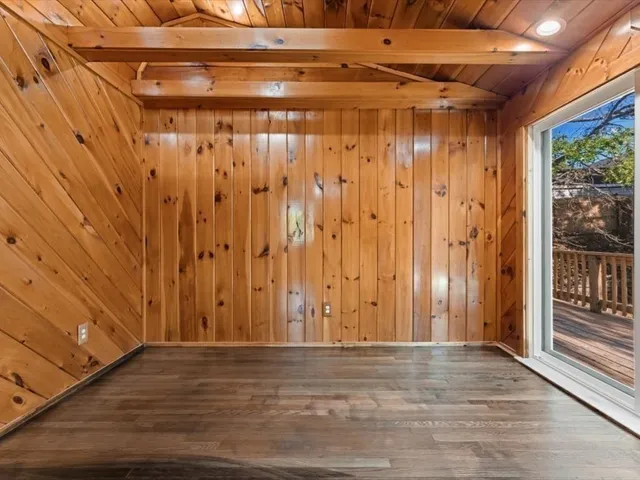 a view of a room with wooden walls