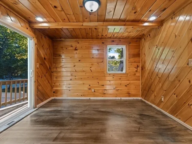 a view of a room with wooden floor and windows