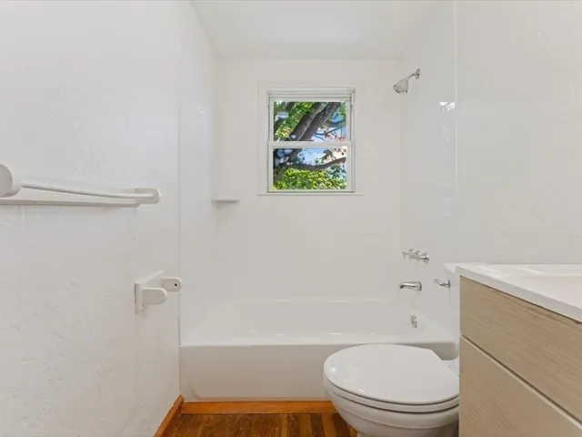 a bathroom with a toilet and a bathtub