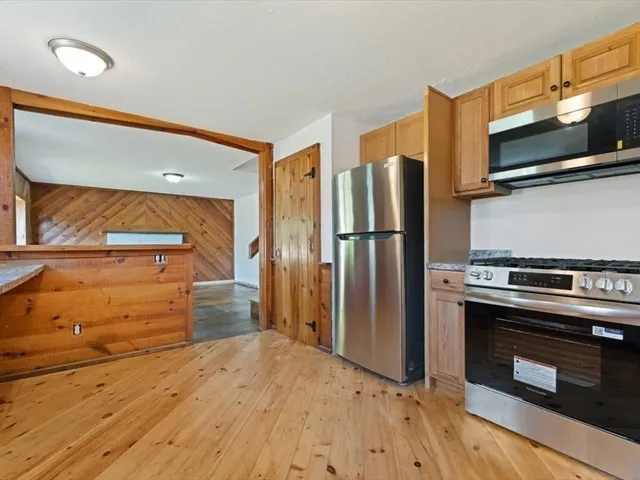 a kitchen with a refrigerator stove and microwave