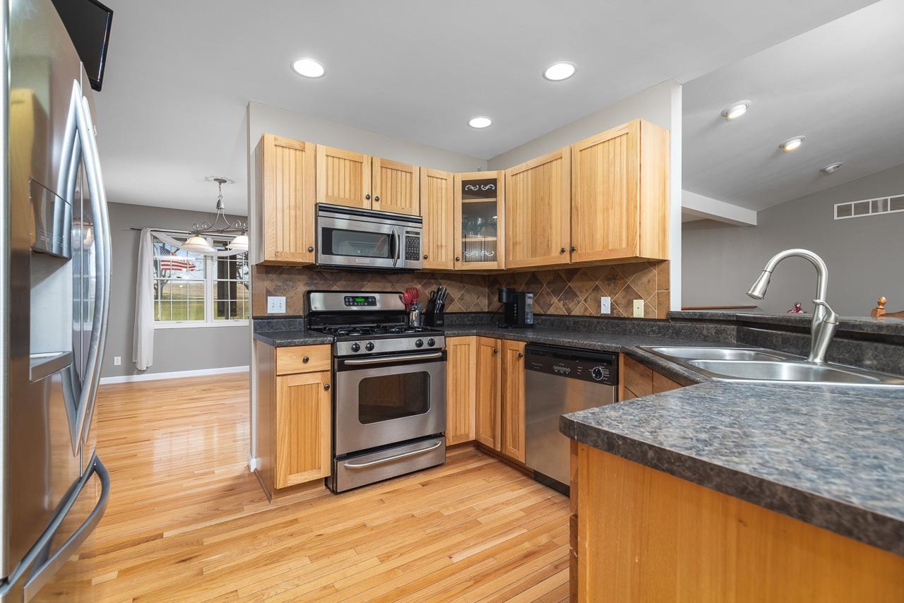 1011 North Dakota Road Ridott, IL 61067 - Photo 11 of 34 a kitchen with stainless steel appliances granite countertop a stove a sink and a microwave