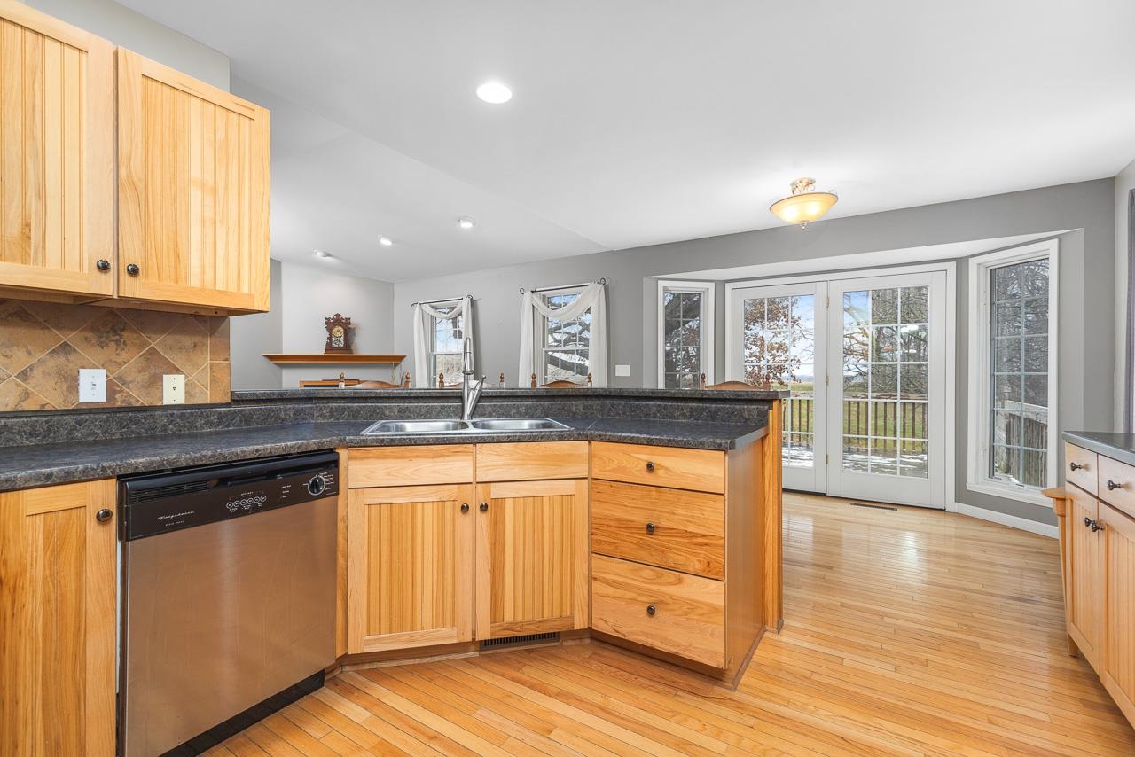1011 North Dakota Road Ridott, IL 61067 - Photo 12 of 34 a kitchen with granite countertop wooden floors and wide window