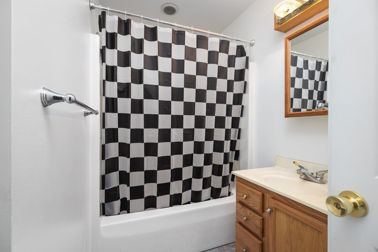 1011 North Dakota Road Ridott, IL 61067 - Photo 14 of 34 a bathroom with a black and white checkered floor