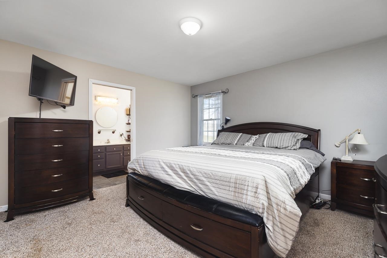 1011 North Dakota Road Ridott, IL 61067 - Photo 16 of 34 a bedroom with a bed and a tv