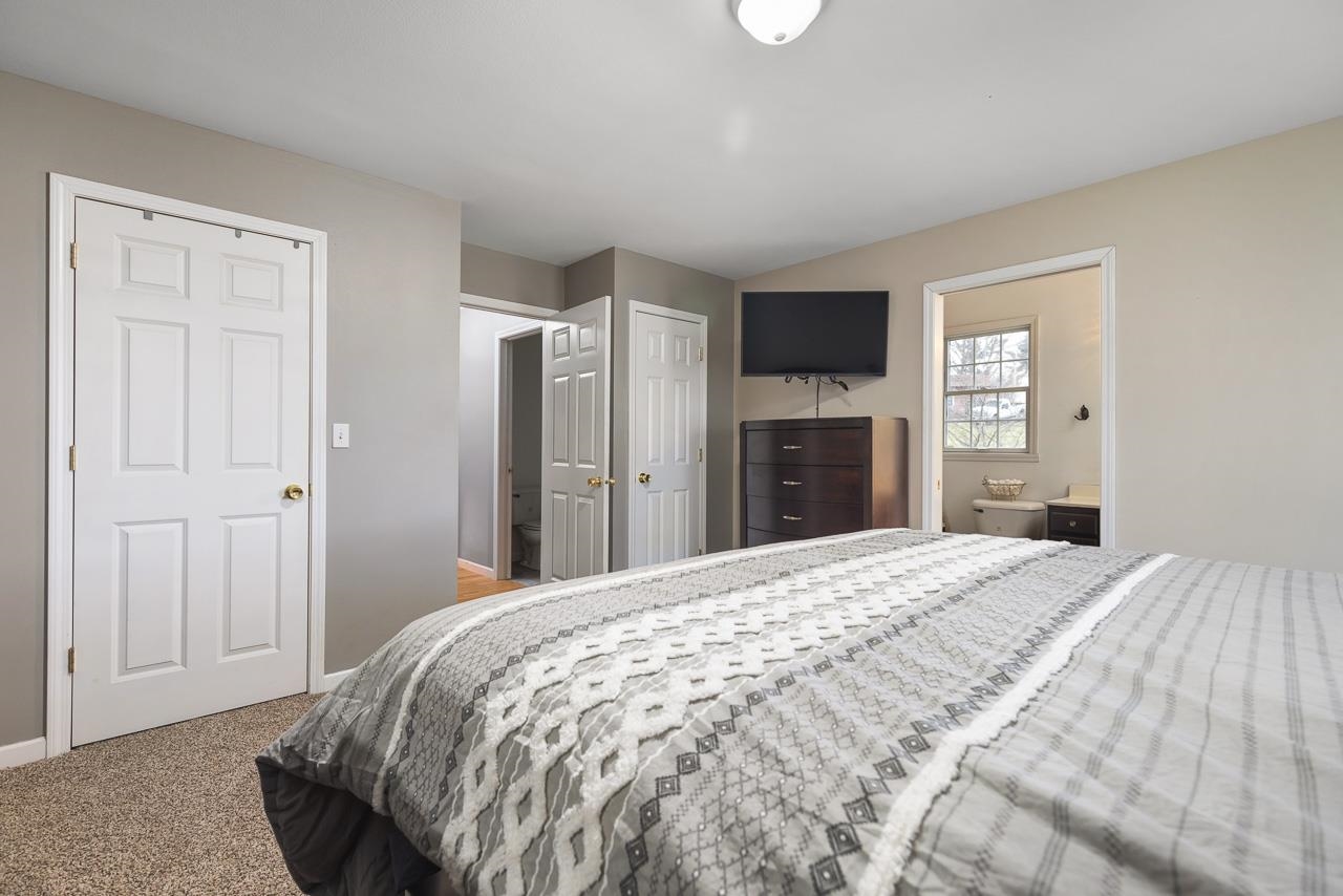 1011 North Dakota Road Ridott, IL 61067 - Photo 18 of 34 a bedroom with a bed and a flat screen tv