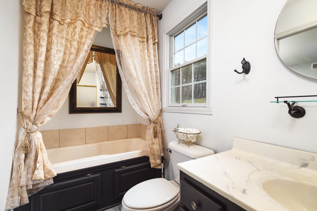 1011 North Dakota Road Ridott, IL 61067 - Photo 21 of 34 a bathroom with a sink toilet and shower