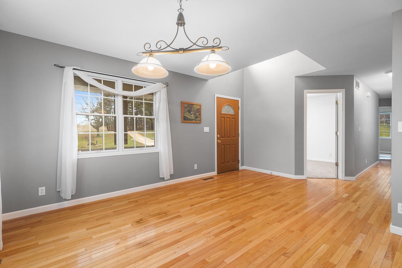 1011 North Dakota Road Ridott, IL 61067 - Photo 4 of 34 a view of an empty room with wooden floor and a window