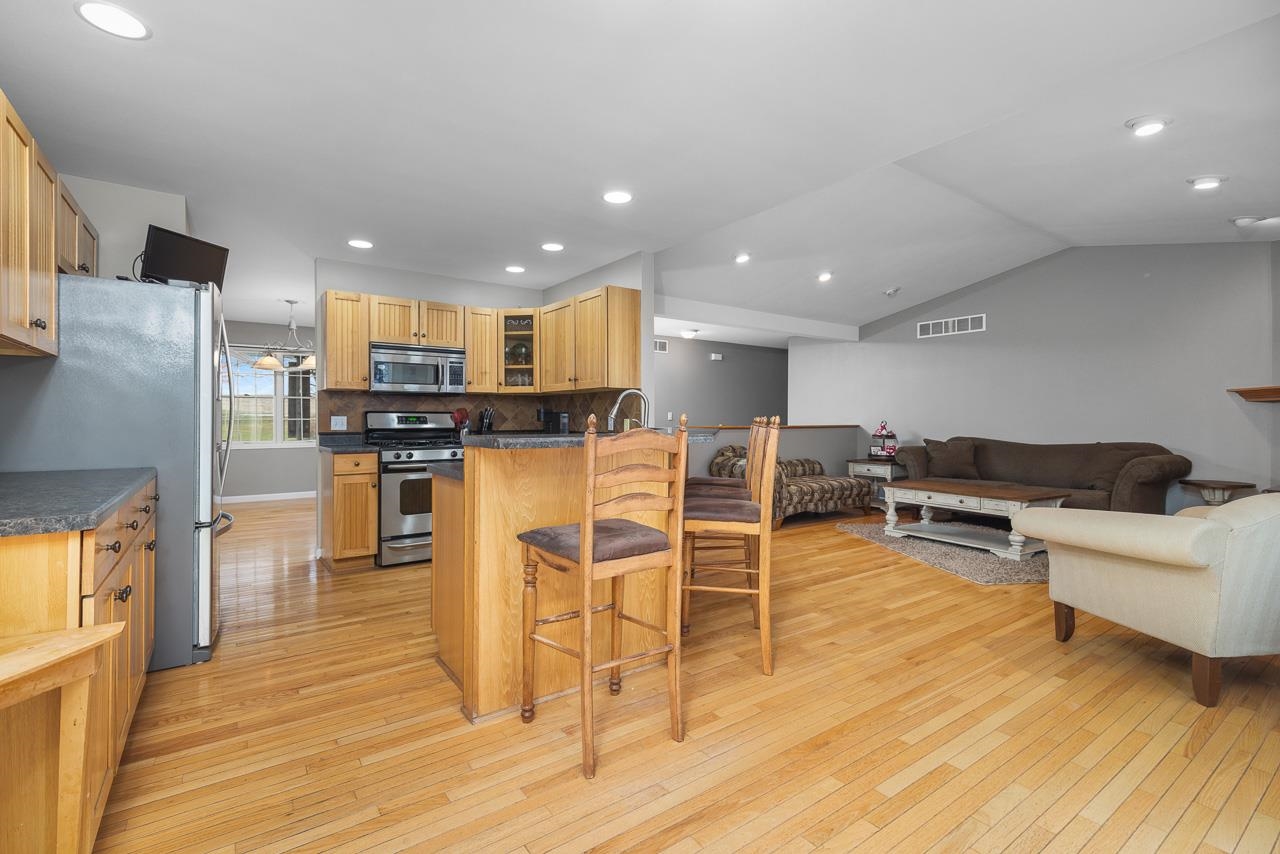 1011 North Dakota Road Ridott, IL 61067 - Photo 10 of 34 a living room with stainless steel appliances furniture wooden floor and a view of kitchen