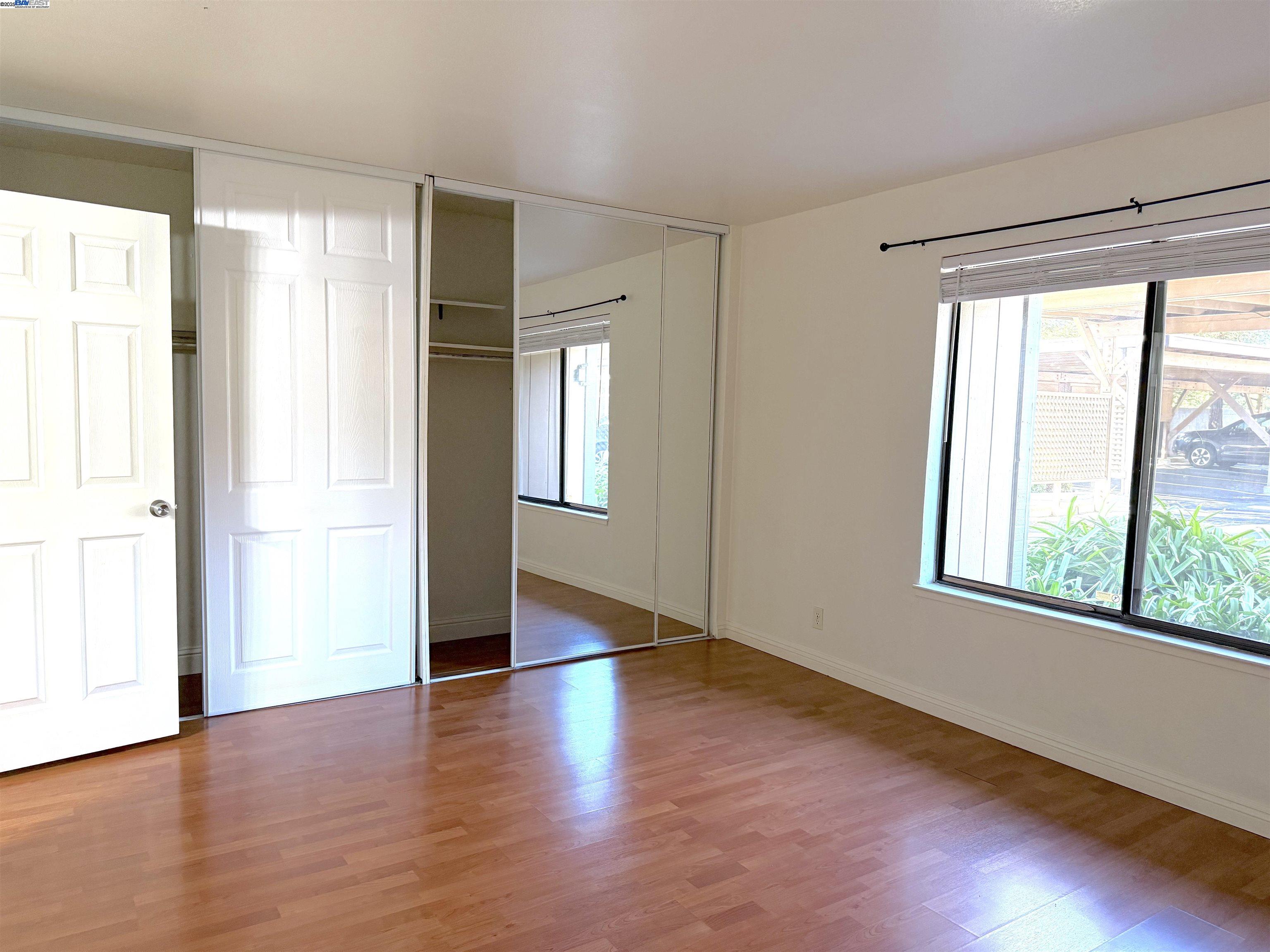 175 East Warren Common Fremont, CA 94539 - Photo 4 of 16 a view of an empty room with wooden floor and a window