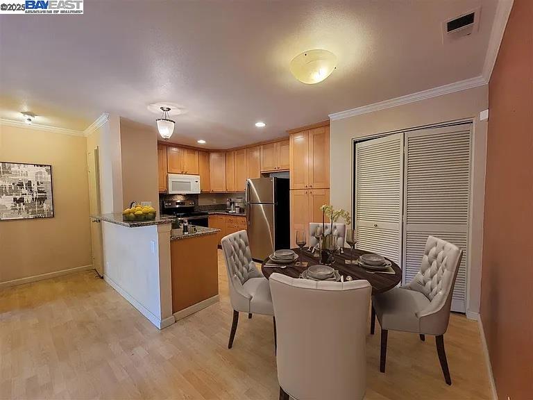 175 East Warren Common Fremont, CA 94539 - Photo 7 of 16 a kitchen with a refrigerator and chairs