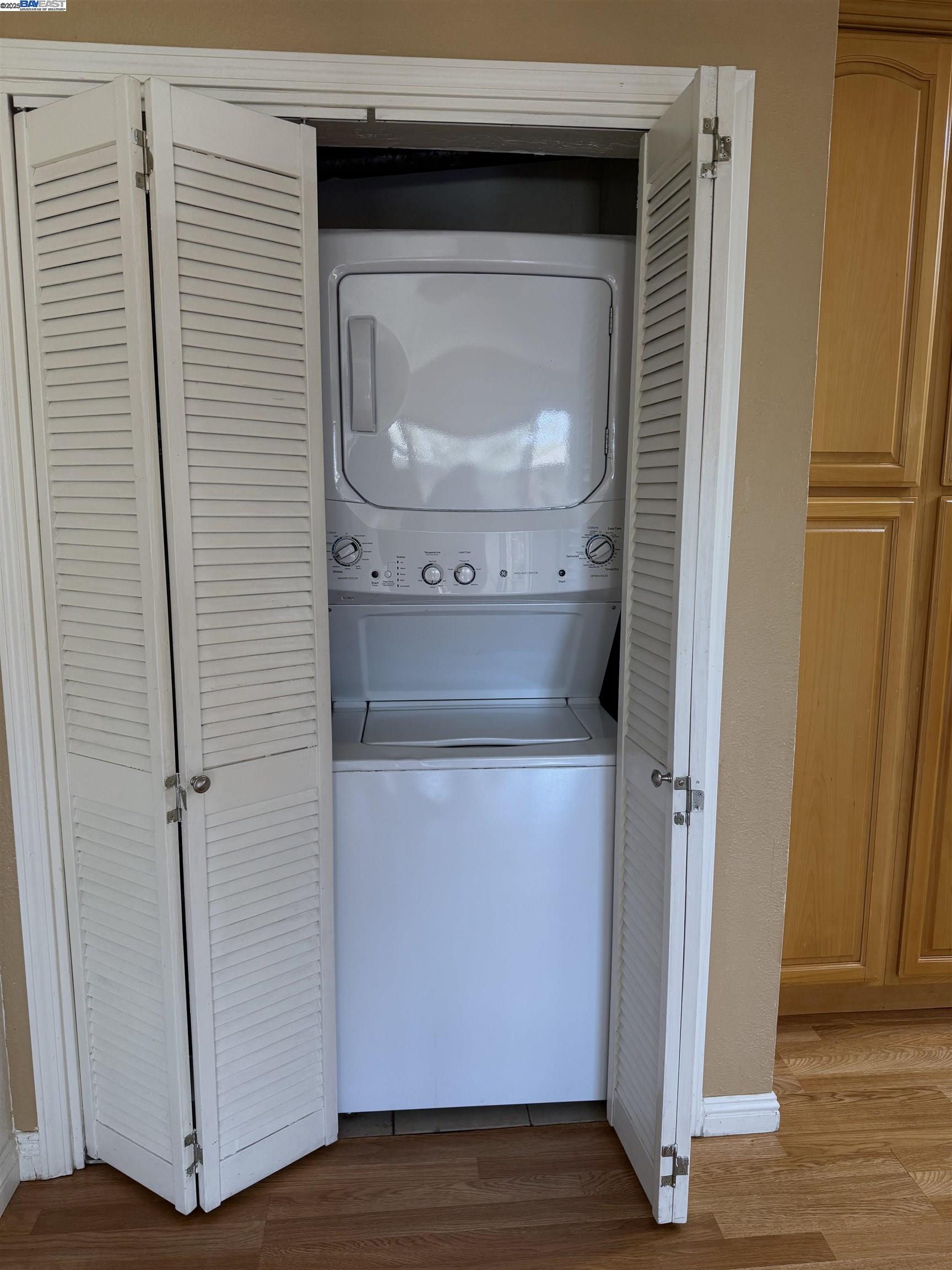 175 East Warren Common Fremont, CA 94539 - Photo 8 of 16 a utility room with wooden floor washer and dryer