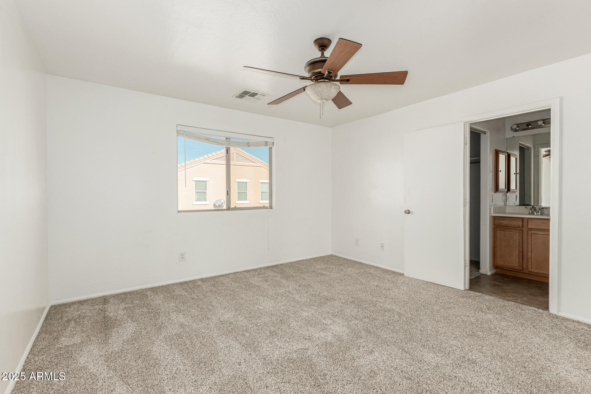 7596 West Charter Oak Road Peoria, AZ 85381 - Photo 17 of 29 a view of a big room with a ceiling fan and a window