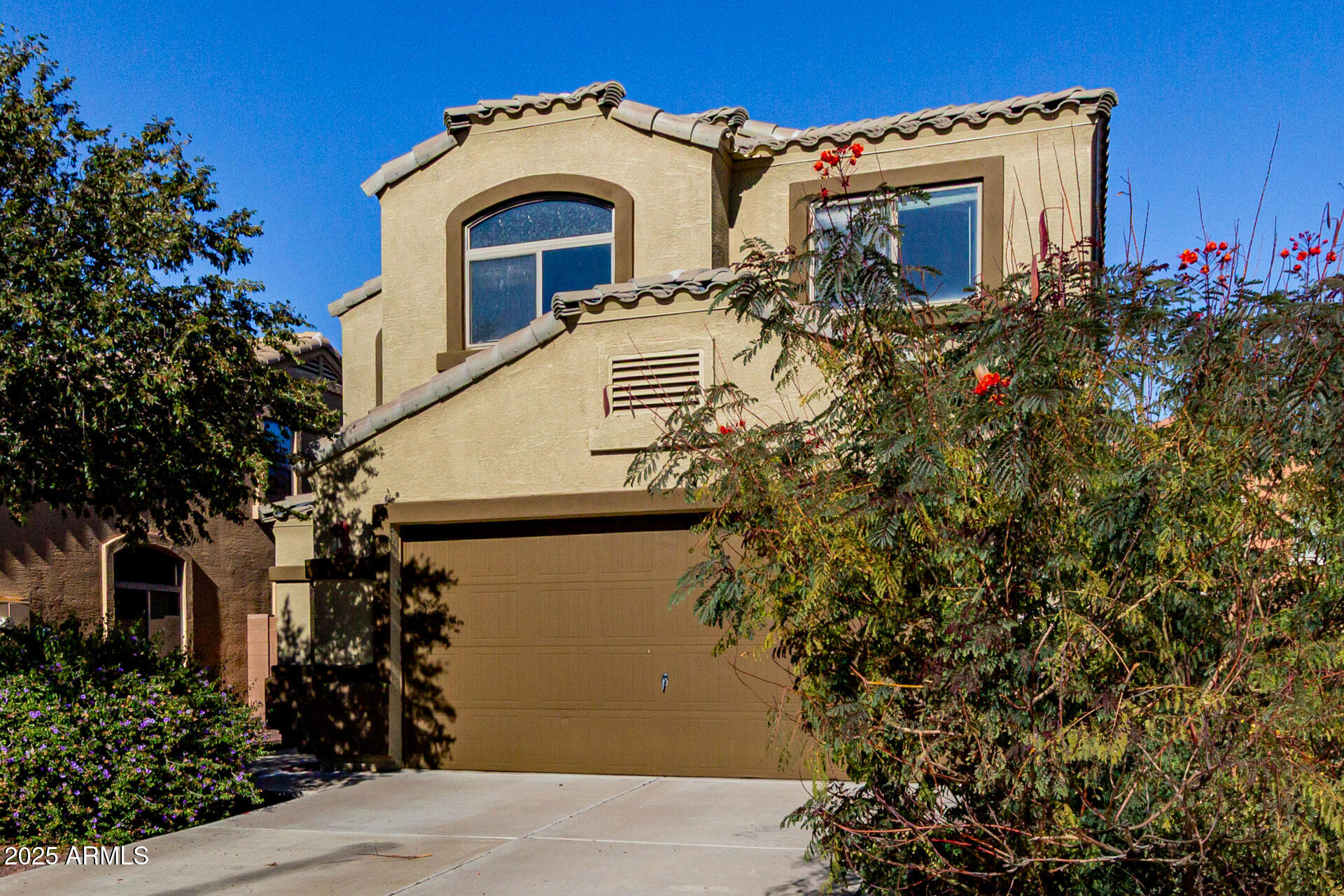 7596 West Charter Oak Road Peoria, AZ 85381 - Photo 2 of 29 a view of a house with a flower garden