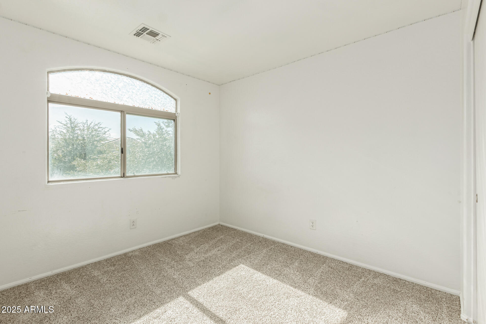 7596 West Charter Oak Road Peoria, AZ 85381 - Photo 22 of 29 an empty room with a window