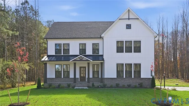 a view of a yard in front of a house with large windows